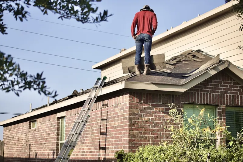 Professional roofer working on a residential roof in Town Park